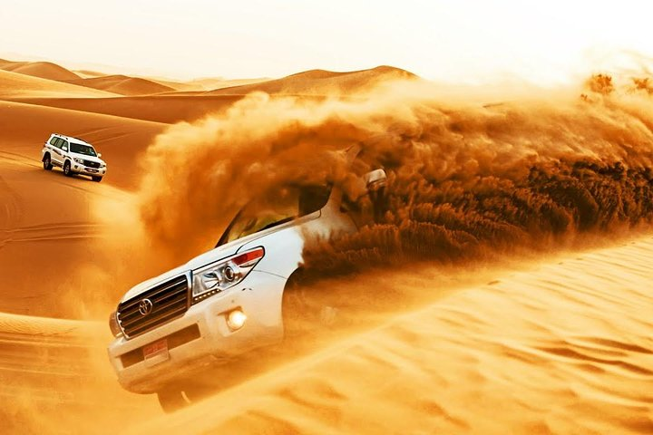 Experience exhilarating dune bashing where powerful vehicles glide over golden sands setting the stage for an unforgettable desert adventure filled with fun and excitement.